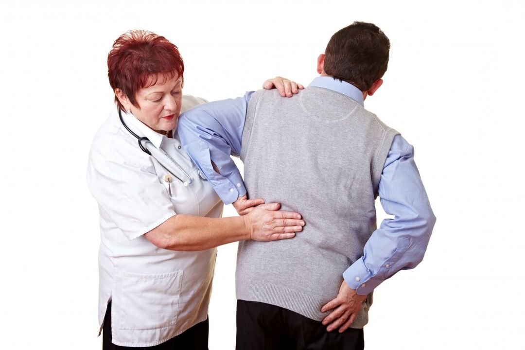 doctor examines a patient with back pain